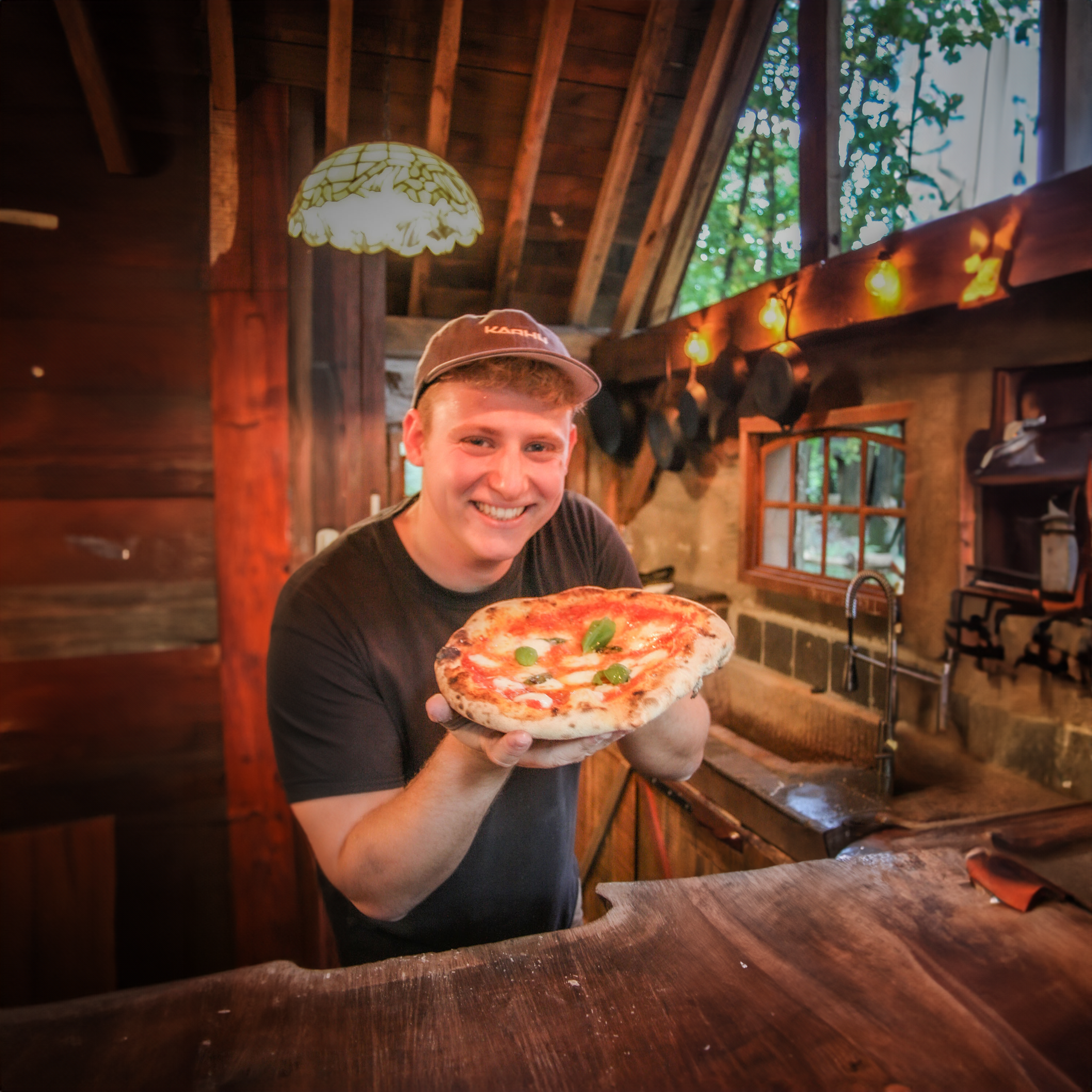 Jurian holding pizza